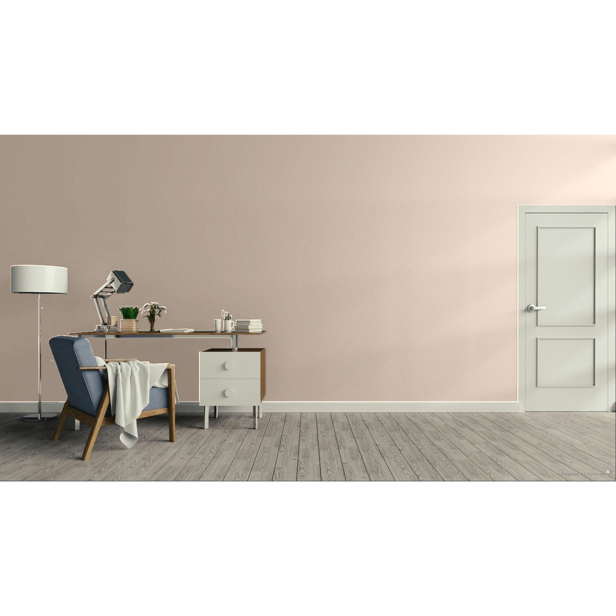 A minimalist interior room scene with a pale blush wall, gray wood floor, a blue upholstered armchair with a draped throw, a desk with a lamp and small accessories, and a white door on the right.