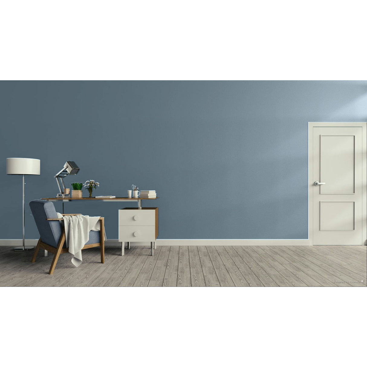 A minimalist room scene with a muted blue-gray wall, light wood floor, a white door on the right, and a desk setup on the left including a chair, lamp, and small cabinet.