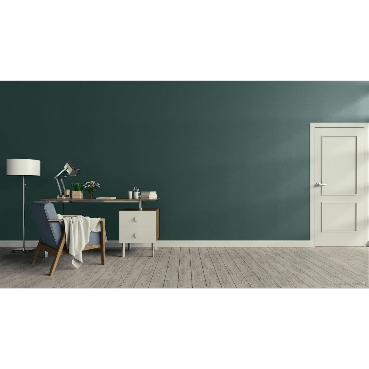 A modern room scene with a dark teal-green wall, light wood plank flooring, a white door on the right, and a home office setup on the left featuring a desk, lamp, chair, and throw blanket.