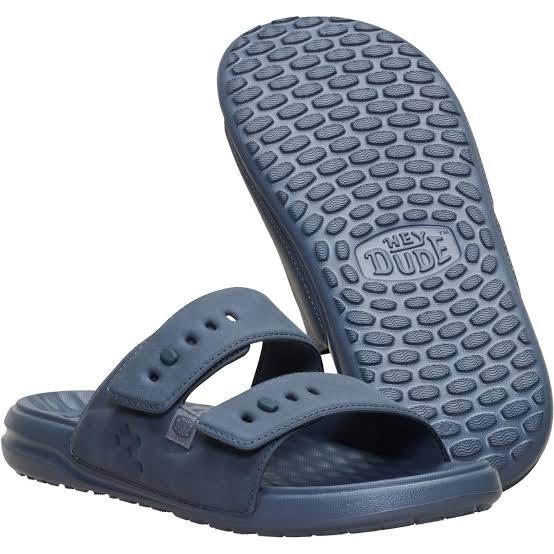 Blue sandals with textured sole on a white background