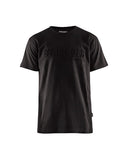 A black short-sleeve crewneck t-shirt with a tonal black embossed 'SHARKLÜDER' logo across the chest, shown on a plain white background.