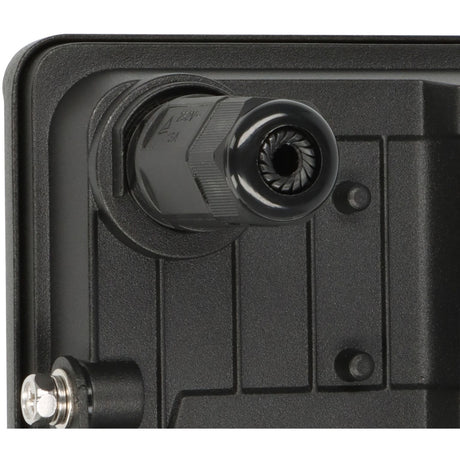 Close-up of a black electronic component with a plug on a black background