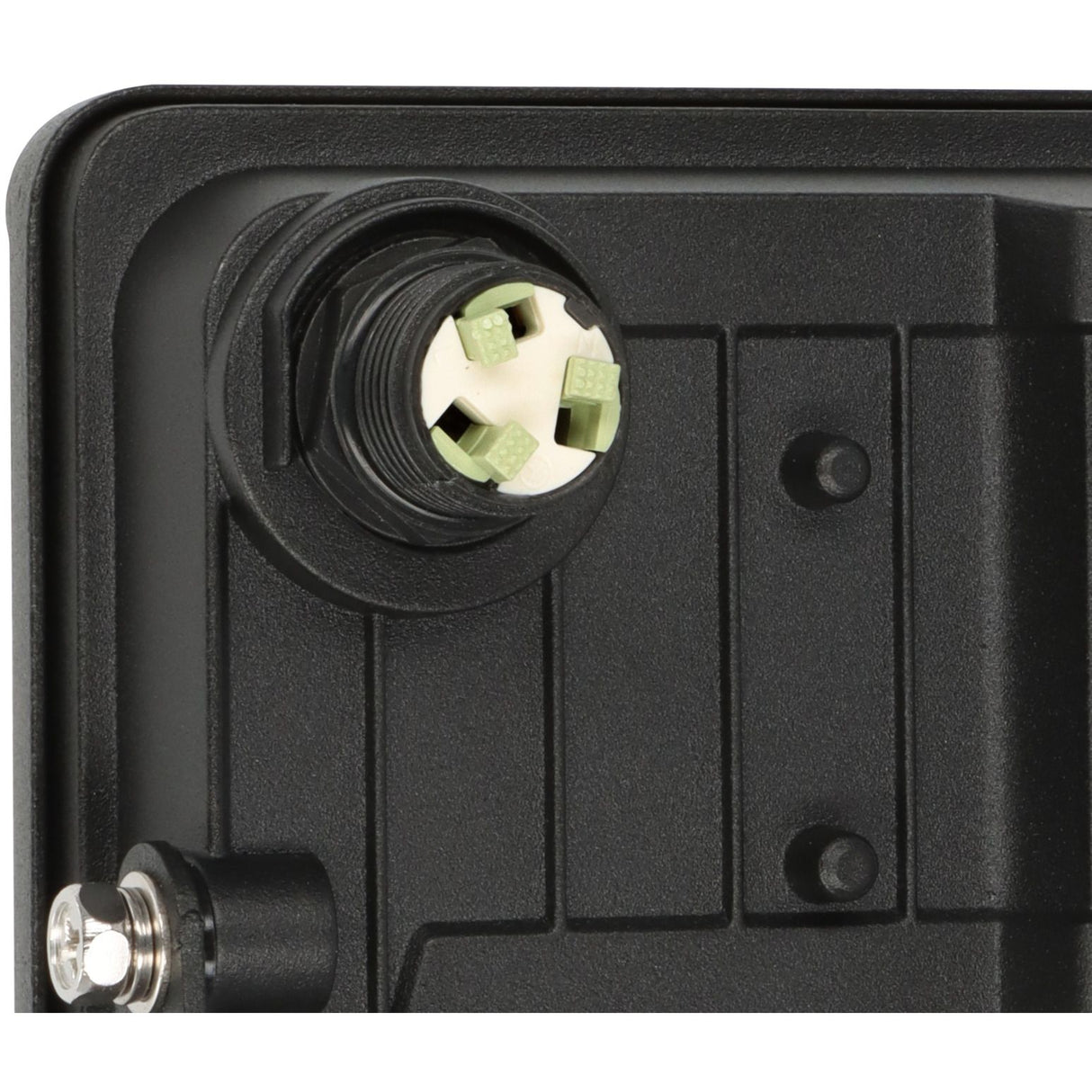 Close-up of a black electrical connector with green screws