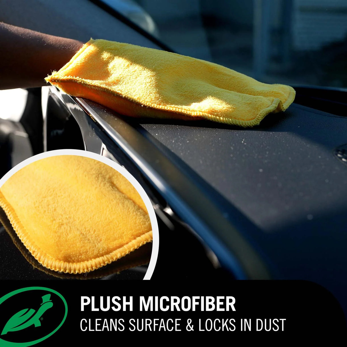 A yellow plush microfiber cleaning cloth being wiped across a black car surface, with a circular inset showing a close-up of the microfiber texture. Text at the bottom reads 'PLUSH MICROFIBER' and 'CLEANS SURFACE & LOCKS IN DUST'.