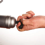 A close-up of a person's hand turning a black plastic cap on a metallic silver cylindrical device against a plain white background.