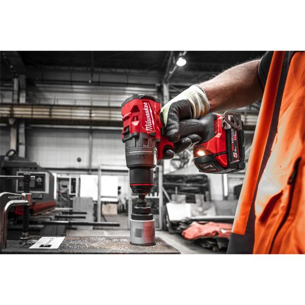 Person using a Milwaukee power drill in an industrial setting