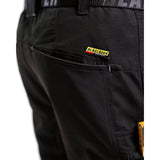 Close-up of black work pants showing a side pocket with a visible Blakleider brand patch.