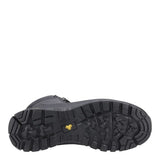 The outsole of a black rugged work boot, showing deep tread patterns and a small yellow logo, photographed against a solid white background.