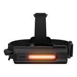 A black headlamp with an illuminated orange-red LED light bar on the front, featuring a padded adjustable strap, shown against a solid white background.