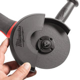 Hand holding a Milwaukee tool with a circular disc attachment on a white background