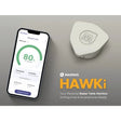 Smartphone displaying app interface next to Magnus Hawk personal radar tank monitor on a gray background