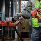 Person using a Milwaukee Sawzall tool in a construction setting