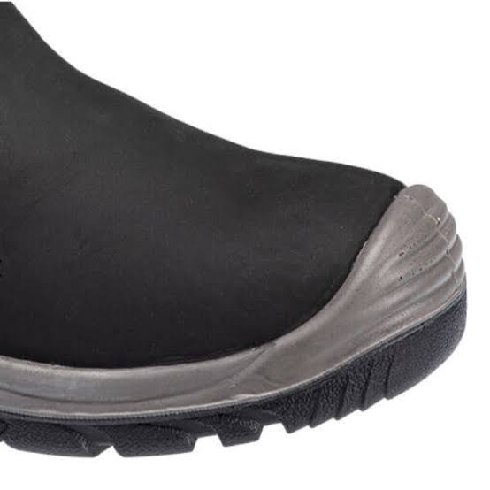 Close-up of a black slip-on shoe or boot toe area with a gray protective bumper and black treaded sole on a white background.