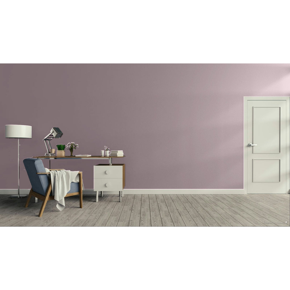 A minimalist room scene with a dusty mauve-pink wall, light wood floor, a white door on the right, and a home office setup on the left featuring a blue armchair, desk, lamp, and side table.