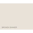 A flat warm light beige color block with the text 'BROKEN SHAKER' printed in dark gray at the bottom left.