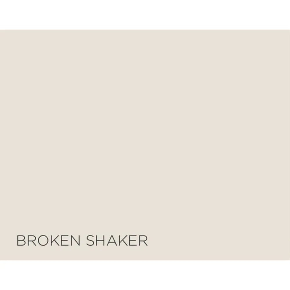 A flat warm light beige color block with the text 'BROKEN SHAKER' printed in dark gray at the bottom left.