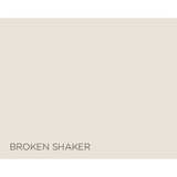 A flat warm light beige color block with the text 'BROKEN SHAKER' printed in dark gray at the bottom left.
