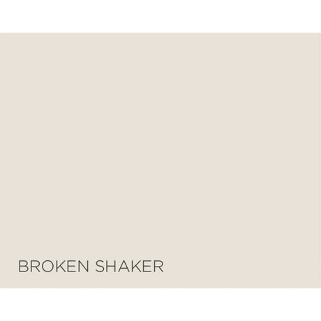 A flat warm light beige color block with the text 'BROKEN SHAKER' printed in dark gray at the bottom left.