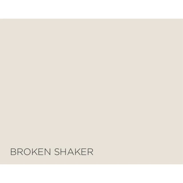 A flat warm light beige color block with the text 'BROKEN SHAKER' printed in dark gray at the bottom left.