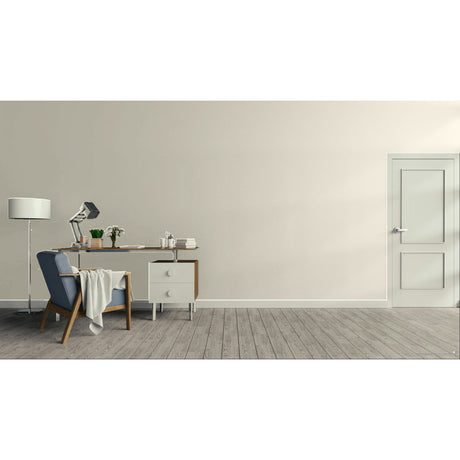 A minimalist interior room with a light beige wall, gray wood floor, a white door on the right, and a home office setup on the left featuring a desk, lamp, chair, and small cabinet.
Prestige Coco Light