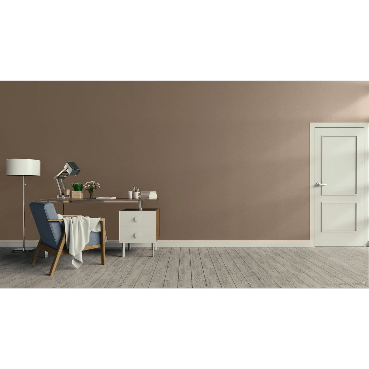 A minimalist room scene with a large warm taupe wall, light wood floor, a white door on the right, and a home office setup on the left featuring a blue armchair, desk, lamp, and small cabinet.