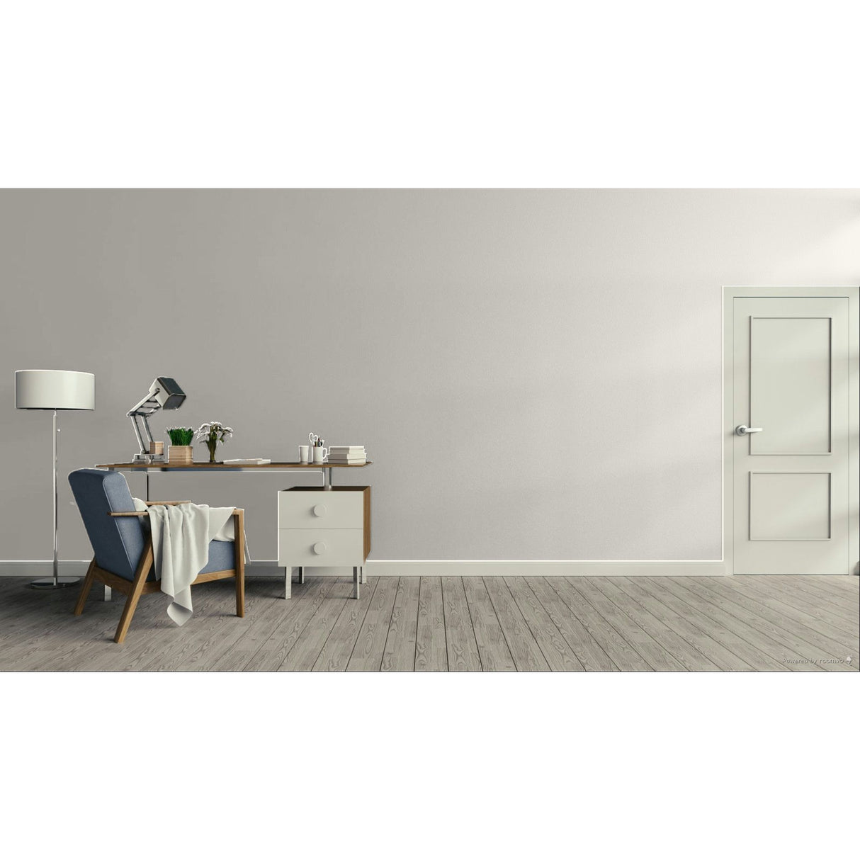 A minimalist interior room with a light gray wall, gray wood floor, a white door on the right, and a furnished study area on the left featuring a desk, lamp, chair, and small cabinet.