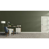 A modern room scene with a dark olive green wall, light wood floor, a white door on the right, and a home office setup on the left featuring a desk, lamp, chair, and small cabinet.
Prestige Monet Dark