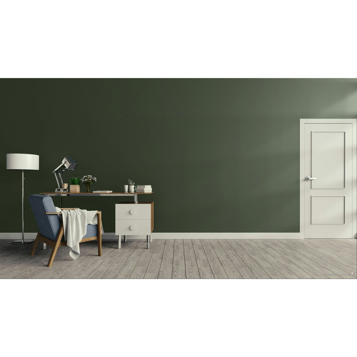 A modern room scene with a dark olive green wall, light wood plank flooring, a white door on the right, and a home office setup on the left featuring a desk, lamp, chair, and throw blanket.