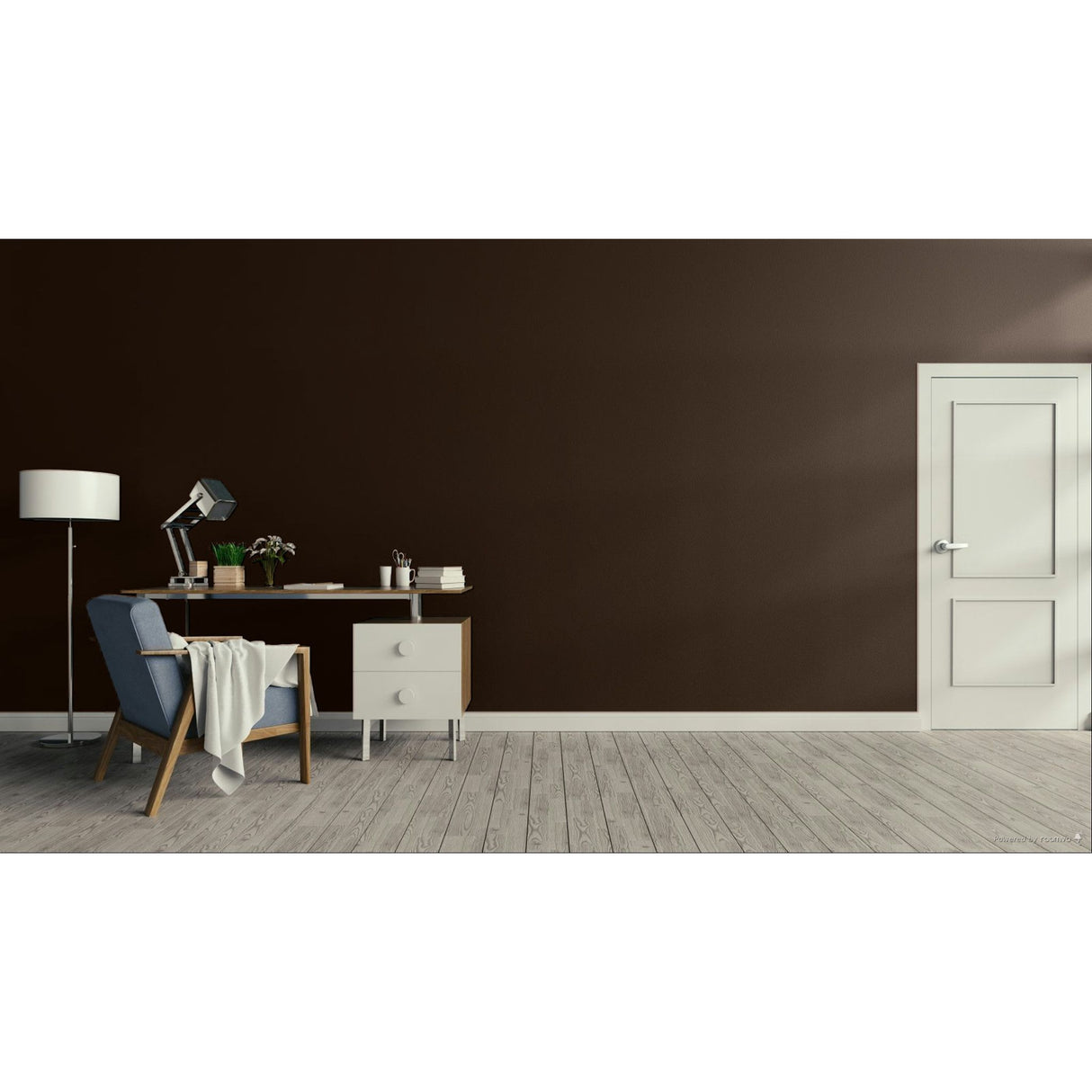 A modern interior room with a dark charcoal wall, light wood floor, a white door on the right, and a home office setup on the left featuring a blue armchair, desk, lamp, and small cabinet.
