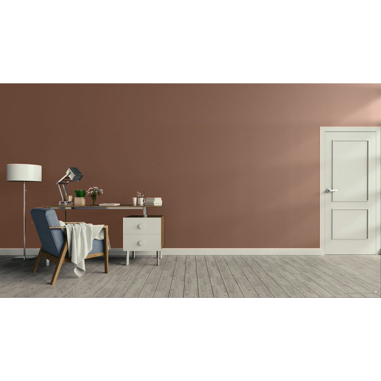 A minimalist room scene with a dusty terracotta brown wall, light gray wood flooring, a white door on the right, and a home office setup on the left featuring a blue armchair, desk, lamp, and side table.