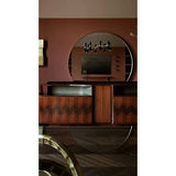 A mid-century modern wooden console cabinet with chevron inlay, a large round wall mirror, and shelving, set against a terracotta-colored wall.