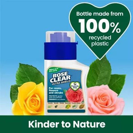 A bottle of Rose Clear Ultra Shield aphid and mite control spray for roses, shown against a bright blue background with decorative yellow and pink roses and green leaves. A green heart-shaped badge states 'Bottle made from 100% recycled plastic' and a green banner at the bottom reads 'Kinder to Nature'.