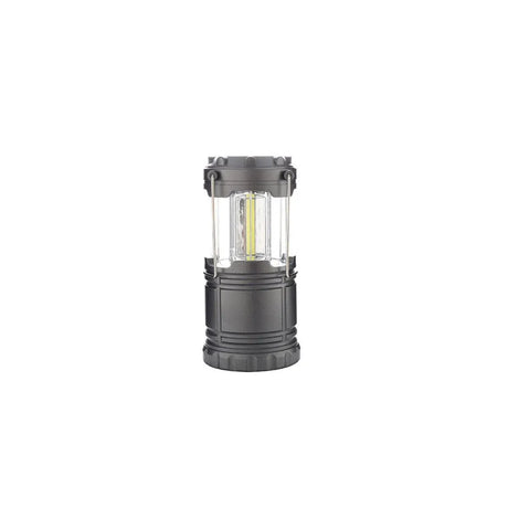A dark gray tactical camping lantern with a clear plastic window showing a yellow LED light inside, set against a plain white background.