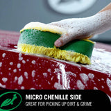 A hand washing a red car with a green and yellow sponge, with a black text banner at the bottom reading 'MICRO CHENILLE SIDE GREAT FOR PICKING UP DIRT & GRIME'. Turtle Wax M.A.X Power™ 3-in-1 Wash Pad