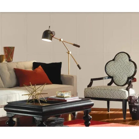 Living room with a sofa, armchair, coffee table, and decorative lamp.