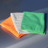 Three folded microfiber cleaning cloths in green, white, and orange stacked on a reflective gray surface.
Turtle Wax Clean & Shine Microfibres - 3 pack