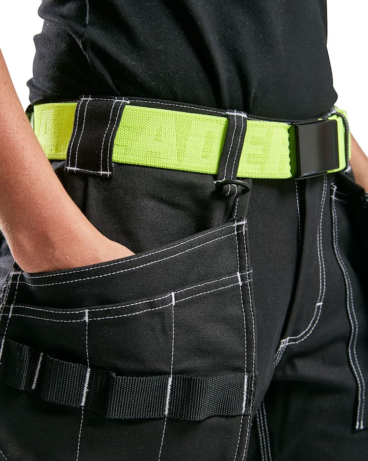 Person wearing black pants with a bright green belt