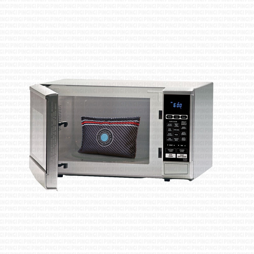 A stainless steel countertop microwave with its door open, showing a dark woven patterned pillow inside. The microwave has a digital control panel on the right side and is set against a white background with a faint repeating watermark pattern.
