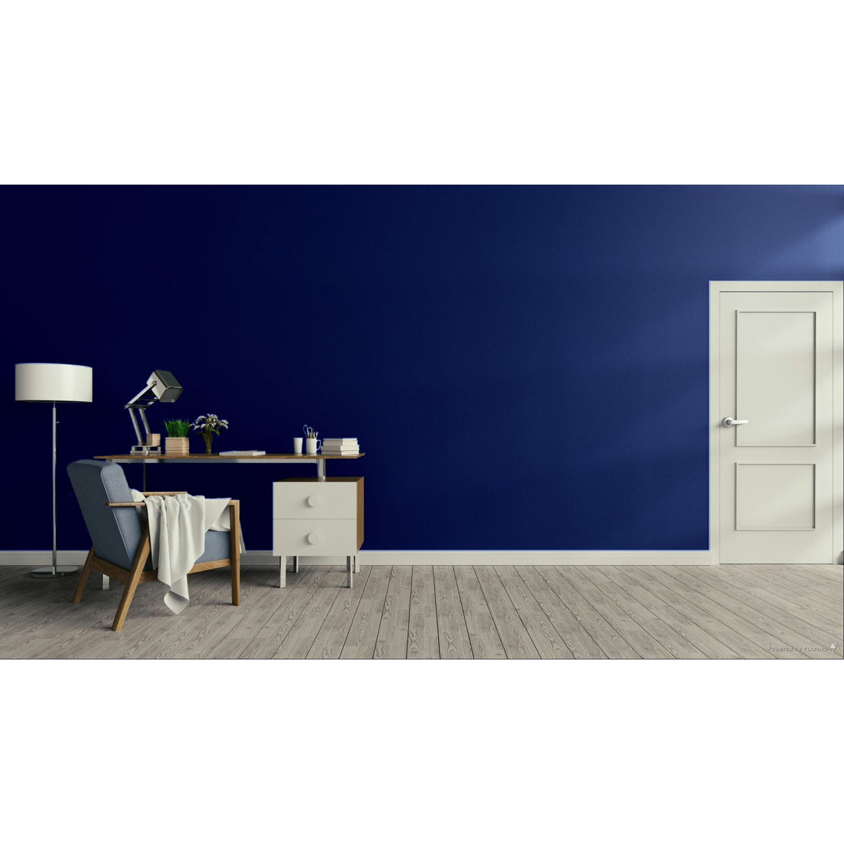 A modern room scene with a deep navy blue wall, light wood flooring, a white door, a desk, chair, lamp, and draped throw blanket.