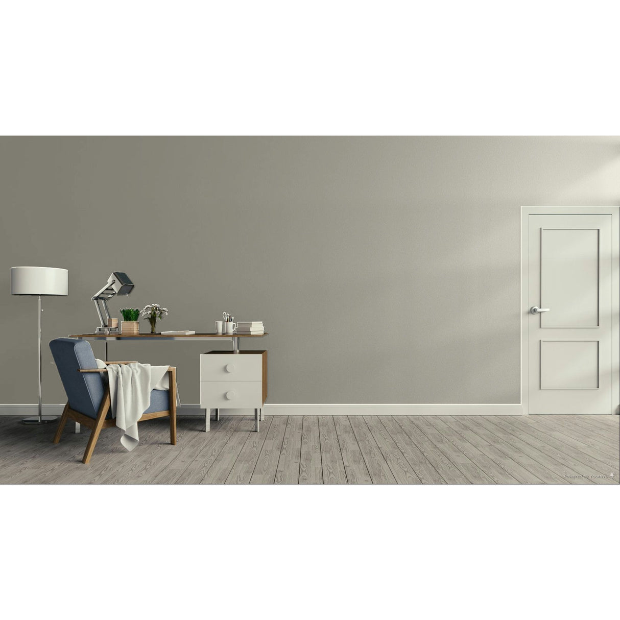 A minimalist room scene with a gray wall, light wood floor, a blue upholstered armchair with a draped throw, a wooden desk with a lamp and small accessories, a white floor lamp, and a white door on the right.